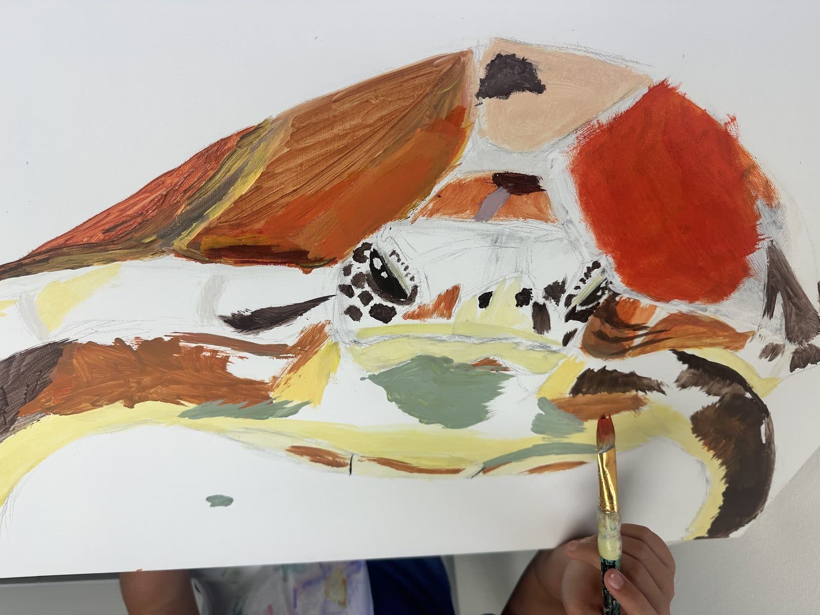 Student painting a colorful still life