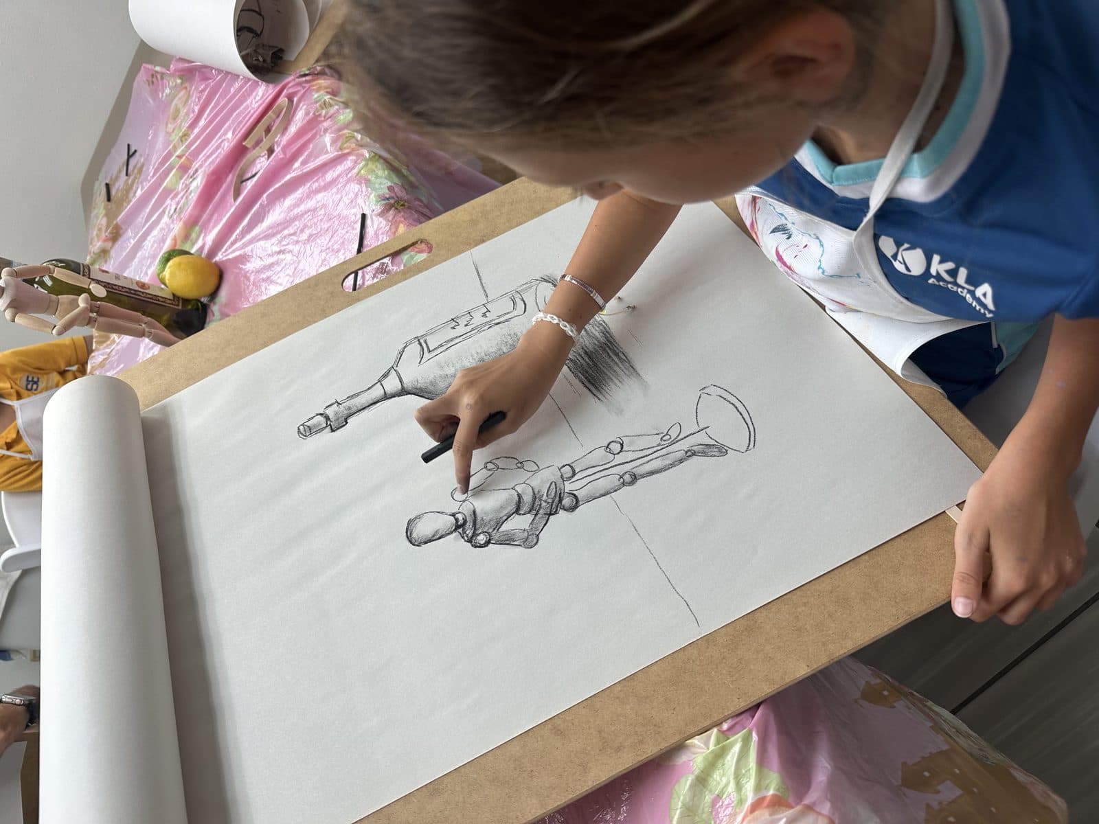 Student sketching a still life in pencil at The Grove Art Studio